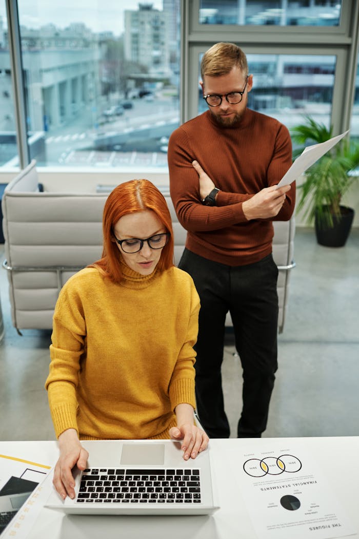 Focused team collaboration in a modern office setting using technology and documents for business strategy.